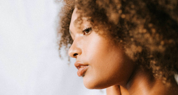 Young woman with afro hair. photo credit Unsplash Huha Inc. 